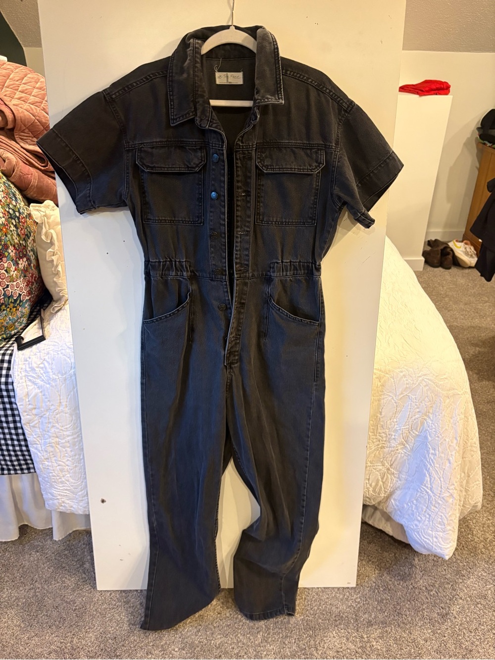 We The Free black denim garment with white label